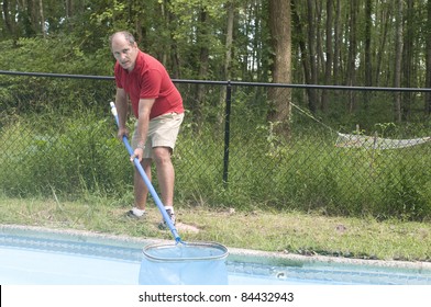 Homeowner Swimming Pool Maintenance Man Cleaning Swimming Pool Skimming Debris From Water Horizontal Composition