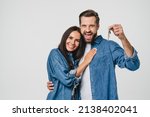 Homeowners. Happy young caucasian couple spouses wife and husband holding car house flat appartment keys, celebrating new purchase buying real estate isolated in white background. Mortgage loan