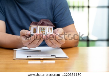 Homeowners selected refinancing of house and checking interest rates and monthly payments. Home mortgage loans from bank concept