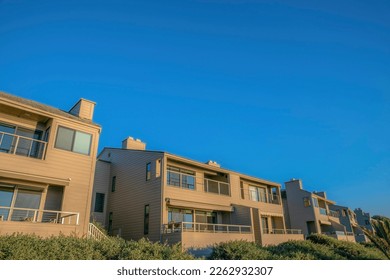 Homes with balconies overlooking beach at sunny Del Mar Southern Califronia. Facade of seaside houses against clear blue sky on a quiet and beautiful sunny day.