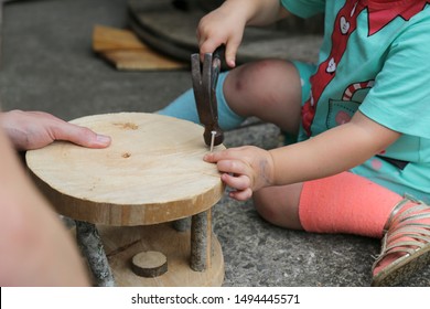 Homeschool Children Real Life Woodwork Tools. Unschooling, Rewilding. Preschool, Kindergarten. STEM Science, Technology Engineering Mathematics. Child Building Helping Dad Hammer And Nail. Odd Socks.