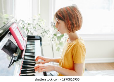 Homeschooling For Children. Girl Learning To Play Piano In Virtual Online School Class On A Digital Tablet. Kid Playing Music At Distant Remote Lesson. Using Wireless Technology For Education.