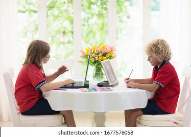 Homeschooling. Kids learning from home. Remote school, online education for young children during quarantine. Kid with laptop and tablet computer. Little girl and boy study. - Powered by Shutterstock