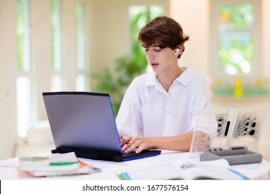 Homeschooling. Kids Learning From Home. Remote School, Online Education For High School Child During Quarantine. College Student With Laptop And Tablet Computer. Teenager Boy Doing Homework.