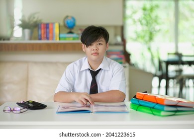 Homeschooling Malaysian Secondary School Student Studying At Home During Pandemic.Asian Child Doing Lesson In Tuition Centre Malaysia.Education In Asia.Kid With Open Book And Files On Desk.Homeschool.