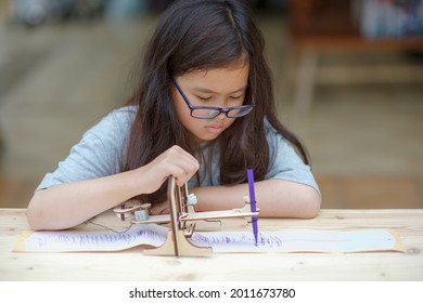 Homeschooling And Seismograph.Child Learning Seismic Technology.Homeschool Student With Earthquake Warning Equipment Sample.Wooden Science And Engineering DIY Craft.Girl Studying Geography.