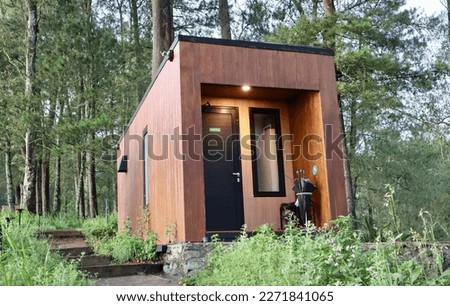 a homestay office made of wood is located in a mountainous area in Batu city, crowded during holidays.