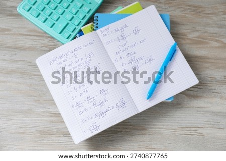 Homework. Notebook with math formulas and different stationery on light grey wooden table, flat lay