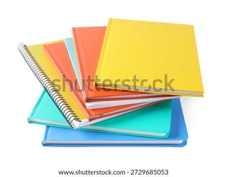 Homework. Stack of colorful notebooks isolated on white