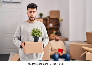 Homosexual Couple Moving To A New Home In Shock Face, Looking Skeptical And Sarcastic, Surprised With Open Mouth 