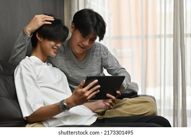 Homosexual Couple, Thailand Gay Men Laughing While Looking At Tablet, LGBT Couples And Everyday Life At Home Concept.