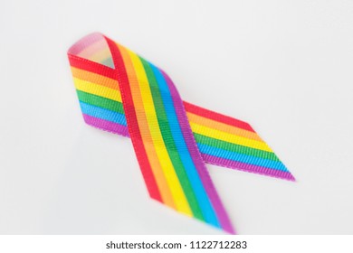 Homosexual And Lgbt Concept - Close Up Of Gay Pride Awareness Ribbon On White Background