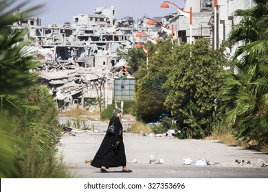 Homs, Syria, September 2013 A Woman Walks Near A Residential Area In The City Of Homs Destroyed In The Fighting Between The Rebels Of The Syrian National Army