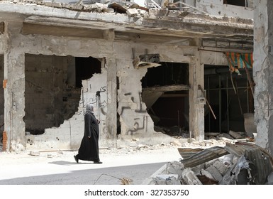 Homs, Syria, September 2013 A Woman Walks Near A House In The City Of Homs Destroyed In The Fighting Between The Rebels Of The Syrian National Army