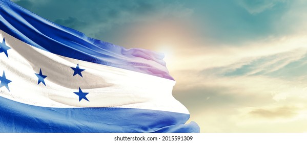 Honduras national flag waving in beautiful sky.