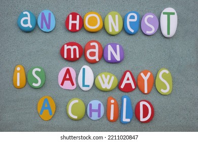 An Honest Man Is Always A Child, Creative Quote Composed With Multi Colored Stone Letters Over Green Sand