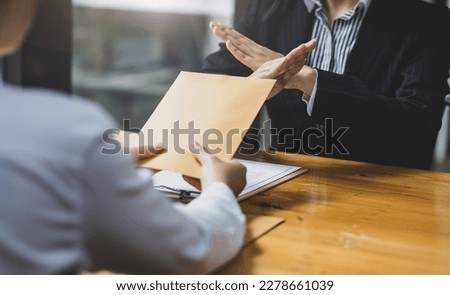 Honest officer refuses to take bribes from criminals. Businesswoman refusing to accept wages or bribes. [[stock_photo]] © 