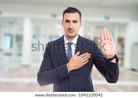 Honest trustworthy real estate agent making oath swear vow gesture on new apartment building lobby background