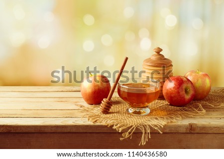 Honey and apples on wooden table. Jewish holiday Rosh Hashanah background