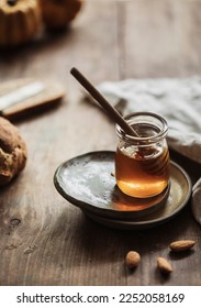 Honey background  Sweet honey comb  glass jar and hazelnuts  On wooden background 