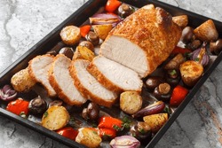 Honey Baked Pork Loin With Potatoes, Onions, Bell Peppers And Mushrooms Close-up On A Baking Sheet On The Table. Horizontal
