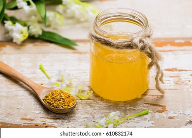 Honey And Bee Pollen On Wooden Table