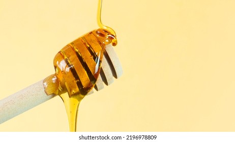 Honey Being Poured On A Dipper. Health And Beauty Product Sustainable Lifestyle Concept. Close Up Shot With Copy Space.