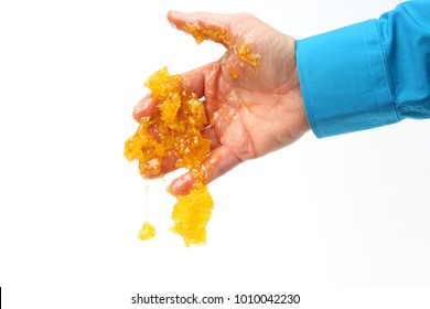 Honey Comb Dripping With Human Hands On White Background