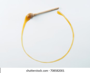 honey dipper with honey in circle form. Honey was poured on black background with copy space. Design concept. Space for text.
