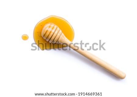 Honey with honey dipper isolated on white background. Top view. Flat lay.