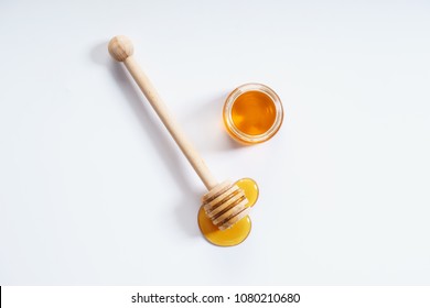 Honey Dipper And Honey Jar On White Background