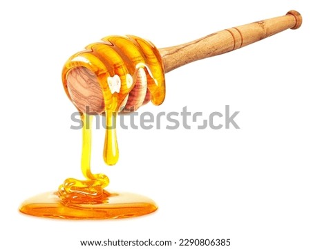 honey dripping with dipper isolated on white