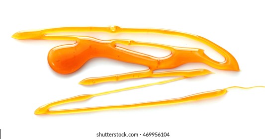 Honey dripping from a wooden dipper. Isolated on a white background. - Powered by Shutterstock