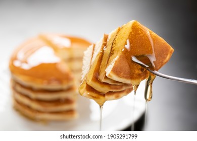 Honey flows into the cut pancakes