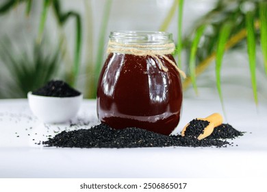 Honey in a glass jar with black cumin seeds on a table - Powered by Shutterstock