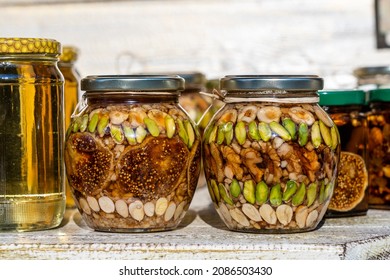 Honey In A Glass Jar With Nuts And Fruits For Sell For Tourist In Montenegro Food Market, Close Up