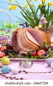 Honey Ham On Easter Table With Eggs, Flowers And Decoration