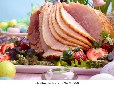 Honey Ham On Easter Table With Eggs, Flowers And Decoration