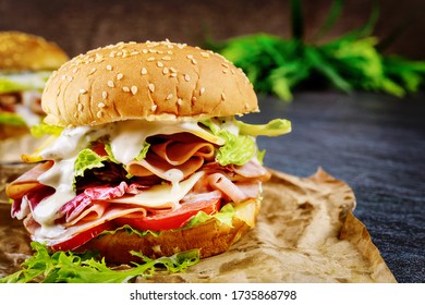 Honey Ham Sandwich With Lettuce, Tomato And Cheese On Dark Background.