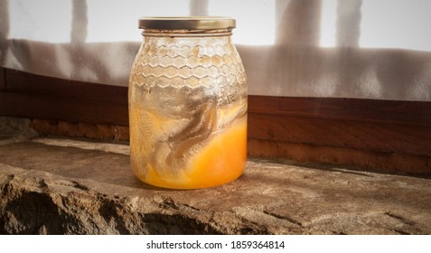 Honey Jar Almost Empty On A Stone Window Ledge