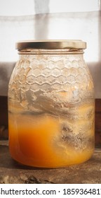 Honey Jar Almost Empty On A Stone Window Ledge