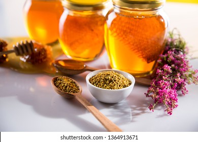 Honey in jar with honey dipper on wooden background. - Shutterstock ID 1364913671