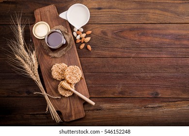 Honey in a jar, on an old vintage planked wood table from above. Rural or rustic style breakfast concept. Background layout with free text space.