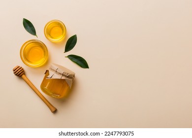 Honey jar with wooden honey dipper on white background top view with copy space. Delicious honey bottle. - Shutterstock ID 2247793075