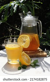 Honey lemon drink or Lemon tea drink in transparent glass and jar. 
