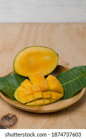 Honey Mango Fruit In A Wooden Plate.