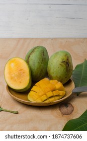 Honey Mango Fruit In A Wooden Plate.