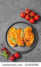 Honey Mustard Grilled Chicken Breasts, Cast Iron Skillet, Dark Background. Top View.