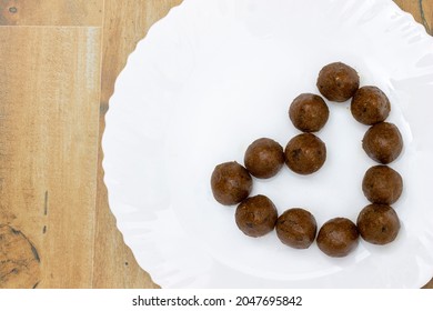 Honey Oats Laddu In White Plate Heart Healthy Symbol