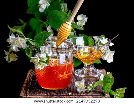 Similar – Cup with acacia blossoms Tea with spoon and honey